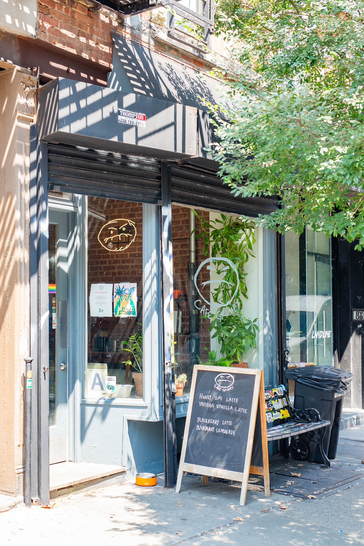 Exterior shot of the small Cafe Grumpy storefront in the Lower East Side, with a chalkboard sign advertising specialty lattes, best Lower East Side coffee shops