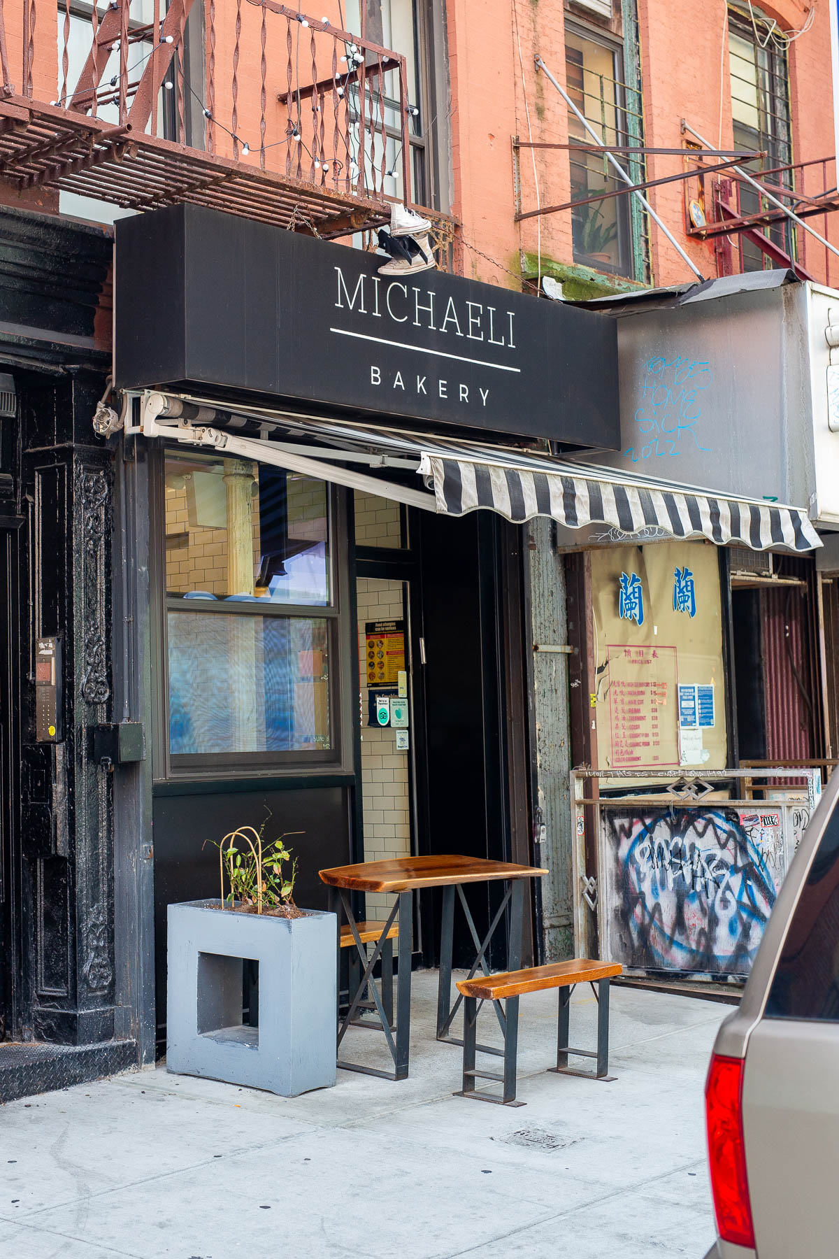 Street view of a an empty table outside of Michaeli Bakery